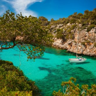 Small,Yacht,Floating,In,Azure,Sea,In,The,Village,Cala Small,Yacht,Floating,In,Azure,Sea,In,The,Village,Cala